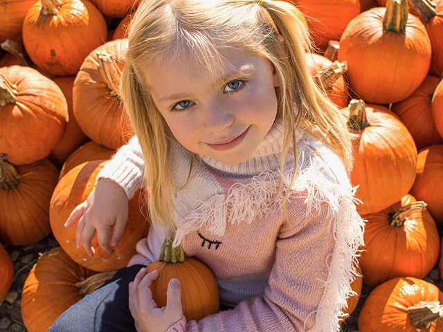 blond girl with pumpkins.jpg