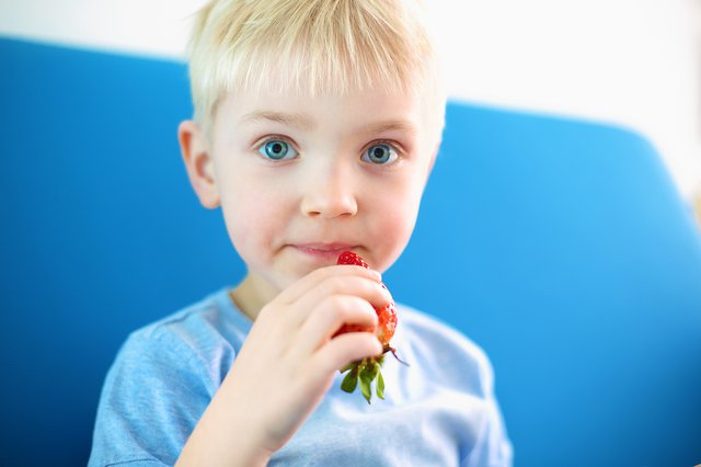 boy eating strawberry.png